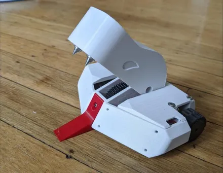 A 150 g crusher robot with a hinged spiked jaw